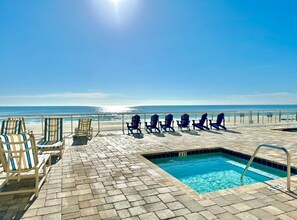 A poolside area with lounge chairs and a small pool.