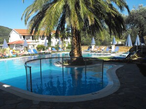 Seasonal outdoor pool, open 9:30 AM to 6:30 PM, pool loungers