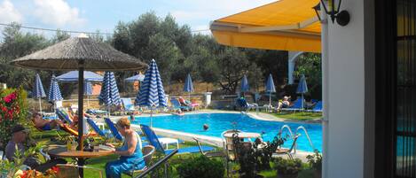 Seasonal outdoor pool, open 9:30 AM to 6:30 PM, pool loungers