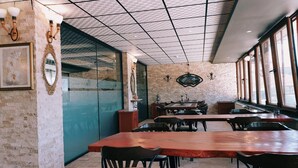 A restaurant with brick walls, large windows, and a tiled ceiling. - Royal Park Hotel Corlu (Corlu)