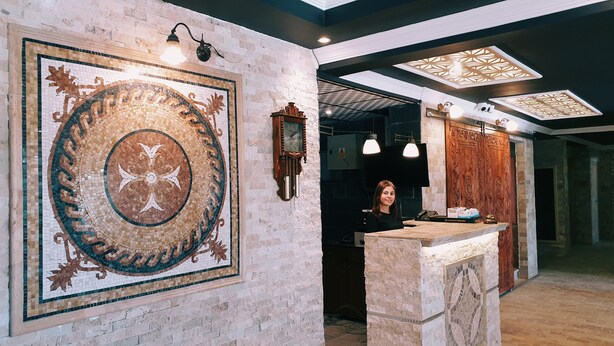 A lobby with a large mosaic wall, a reception desk, and a modern ceiling design. - Royal Park Hotel Corlu (Corlu)