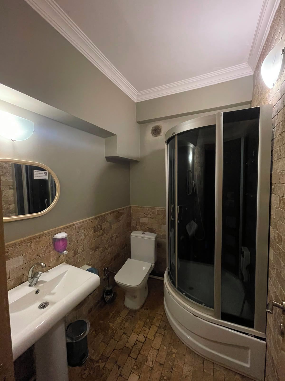 A bathroom with a sink, toilet, and a walk-in shower.