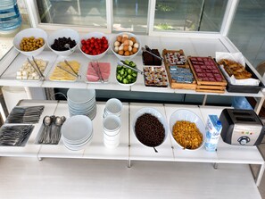 A buffet setup with various food items and utensils. - Royal Park Hotel Corlu (Corlu)