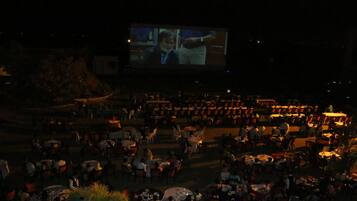 A large outdoor cinema with rows of seating facing a screen.