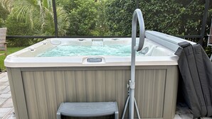 A hot tub with a step and a hose. - Private Pool, HotTub and Golf Cart in the Village of Rio Grande! (The Villages)