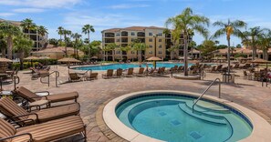 A resort with multiple swimming pools, lounge chairs, and palm trees. - Great View Condo, 2 Min. from Disney World!- 70 (Orlando)