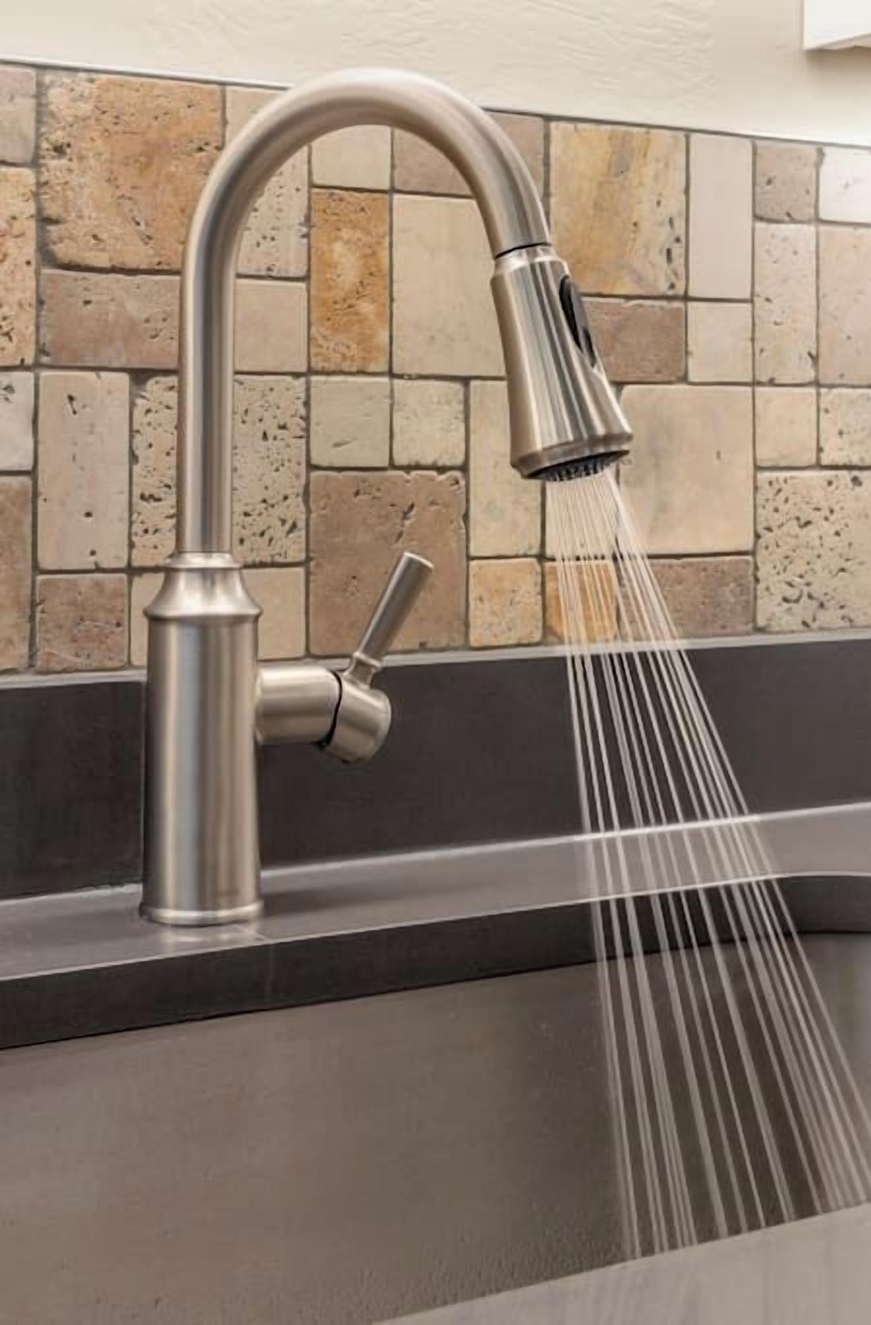 A modern kitchen with a stainless steel faucet and a tiled backsplash.