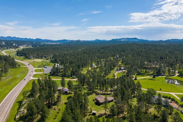 A residential area with houses, a road, and a forested landscape. - One Level Log Home on 3.5 Acres, Beautiful Views, Newly Updated (Custer)
