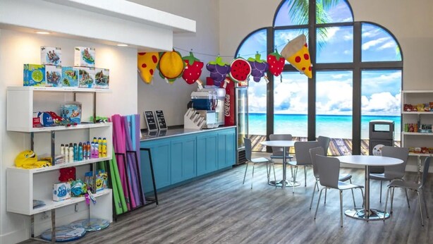 A children's play area with colorful toys, a snack bar, and a view of the ocean. - Newly Renovated St. George Getaway!! (St. George)