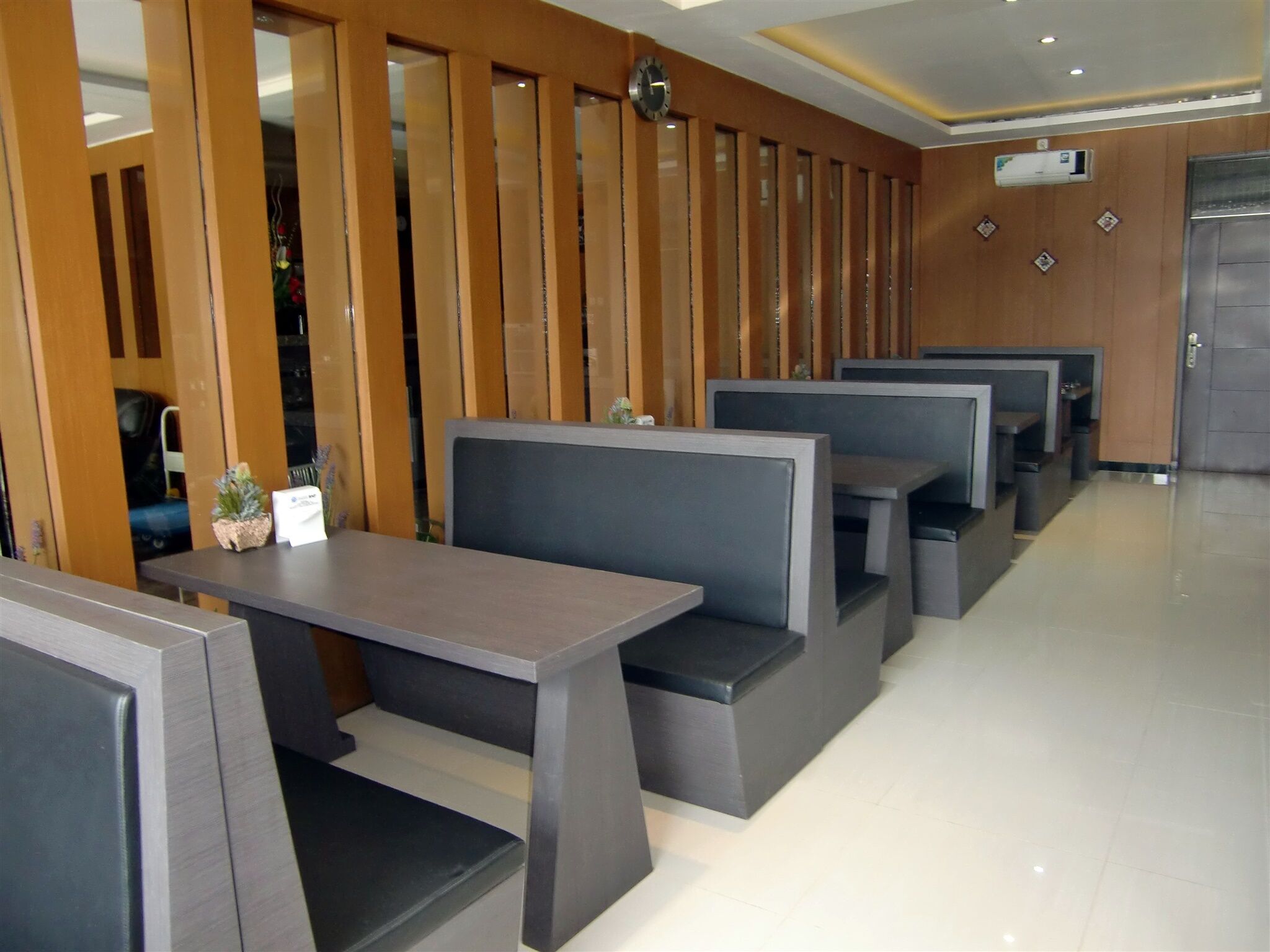 Un restaurant moderne avec des banquettes et une cloison en bois.