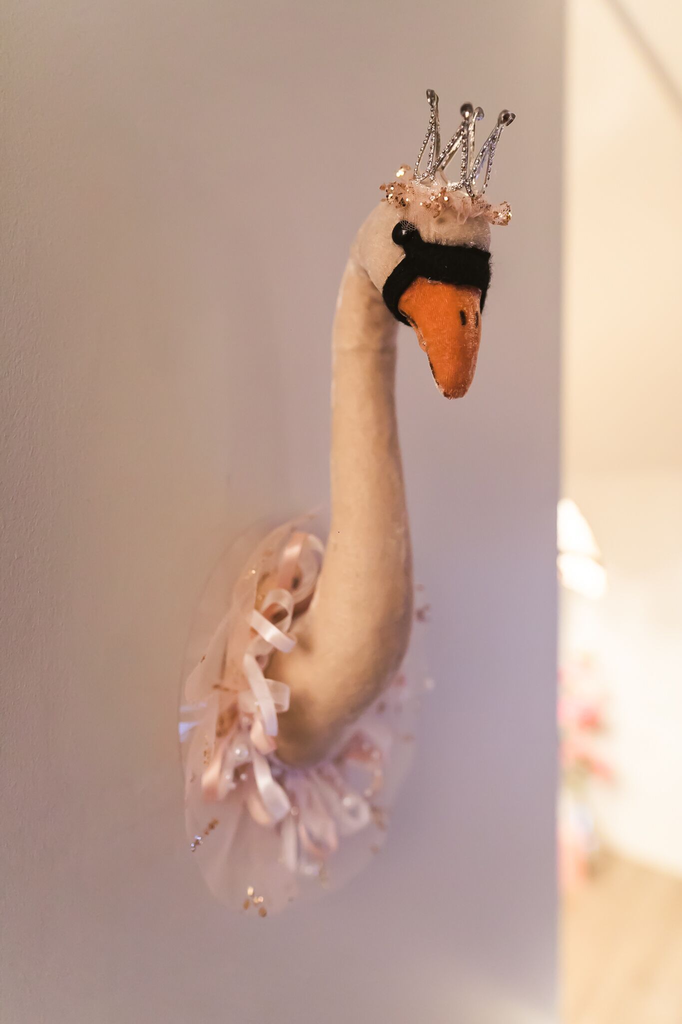 A swan sculpture with a crown and a tutu.