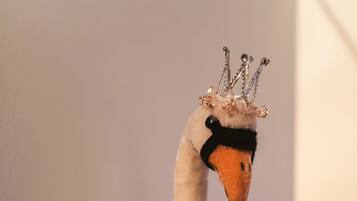 A swan sculpture with a crown and a tutu.