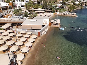 A coastal hotel with outdoor seating and a pool area. - Farrys Boutique Hotel & Beach Club (Bodrum)