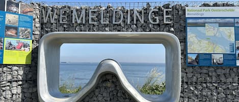 A snorkel mask-shaped entrance to a park with a view of the sea.