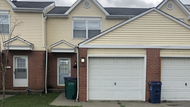 A two-story residential building with a garage, a front yard, and a driveway. - 228 BEAUTIFUL DOWNTOWN AIR/WIFI/close to FALLS (Buffalo)