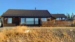 A wooden house with a tiled roof, a visible number '3325', and a gravel driveway. - 4 bedroom cozy home in Sjusjøen (Sjusjøen)