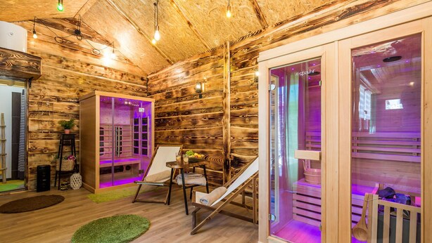 A wooden cabin interior with a sauna, wooden shelves, and a small table with fruits. - Beautiful home in Mrkopalj with sauna (Mrkopalj)