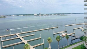 A marina with multiple docks, a boat, and a distant cityscape.
