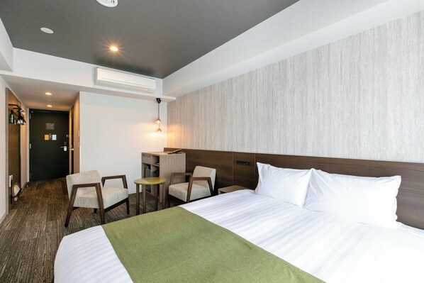 A hotel room with a large bed, two chairs, a small table, and a desk. - KOKO HOTEL Kyoto Sanjo (Kyoto)