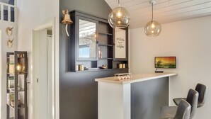 A modern kitchen with a central island, pendant lighting, and a view of the countryside. - 8 bedroom awesome home in Thisted (Thisted)