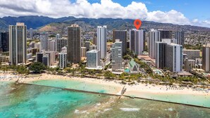 A coastal cityscape with high-rise buildings, a beach, and a clear view of the ocean. - Spacious 14th Floor Corner Suite, Partial Diamond Head and Ocean Views, FREE Parking! (Honolulu)