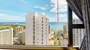 A high-rise building with a view of the ocean and other buildings.