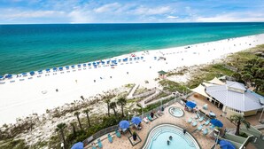 A beach resort with a pool area, beach umbrellas, and lounge chairs. - 🏖️Beachfront, Fab Views-1BR+Bunk Boardwalk 805🏖️ (Panama City Beach)