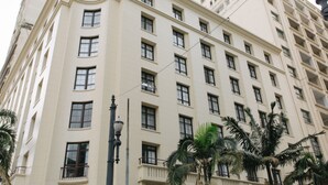 A multi-story building with a symmetrical facade, numerous windows, and balconies. - Jacques Pilon Residence (São Paulo)