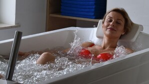 A person relaxing in a bathtub filled with water. - Hotel NAT Jaroslawiec (Postomino)
