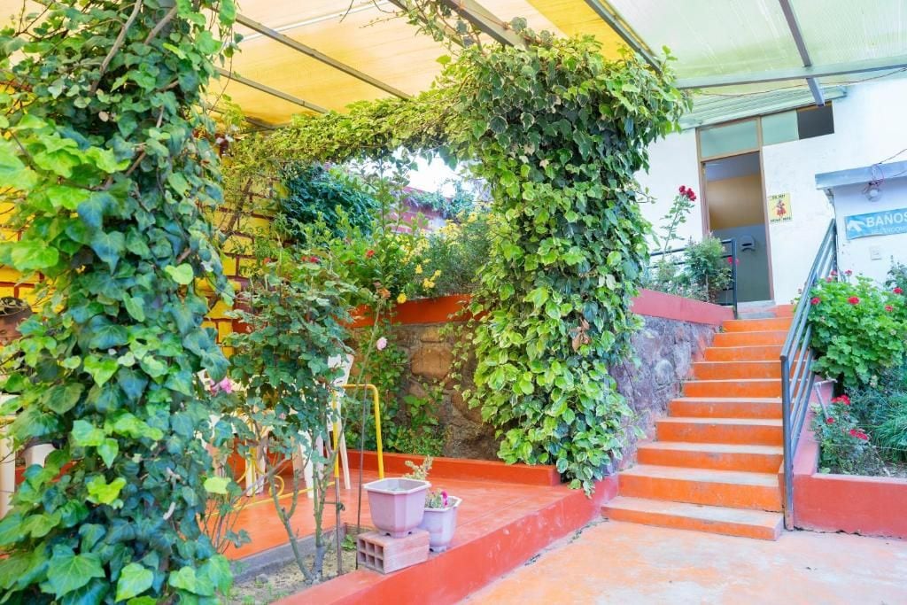A staircase leading up to a building with a covered outdoor area.