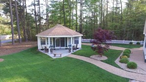 A gazebo with a covered patio, surrounded by well-maintained grass and a white picket fence. - Home AWAY FROM HOME!!! Franklin, VA<br>(1 BEDROOM) (Franklin)