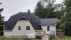 A single-story house with a gabled roof, a front porch, and a small attached garage. - Quiet Waterfront Home (Waddington)
