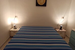 3 dormitorios y tabla de planchar con plancha