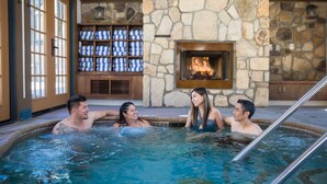A hot tub area with stone walls and a fireplace. - UCLA Lake Arrowhead Lodge (Lake Arrowhead)