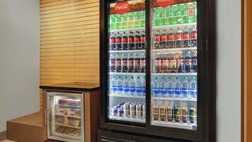 A vending machine with various beverages including Coca-Cola, Sprite, and water.