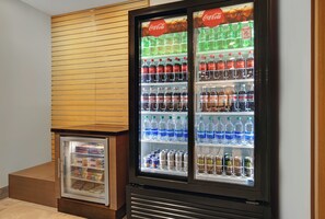 A vending machine with various beverages including Coca-Cola, Sprite, and water. - Holiday Inn Express Milwaukee Downtown by IHG (Milwaukee)