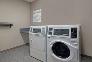A guest laundry area with two front-loading washing machines and a sign indicating it's for guest use only. - Holiday Inn Express Milwaukee Downtown by IHG (Milwaukee)