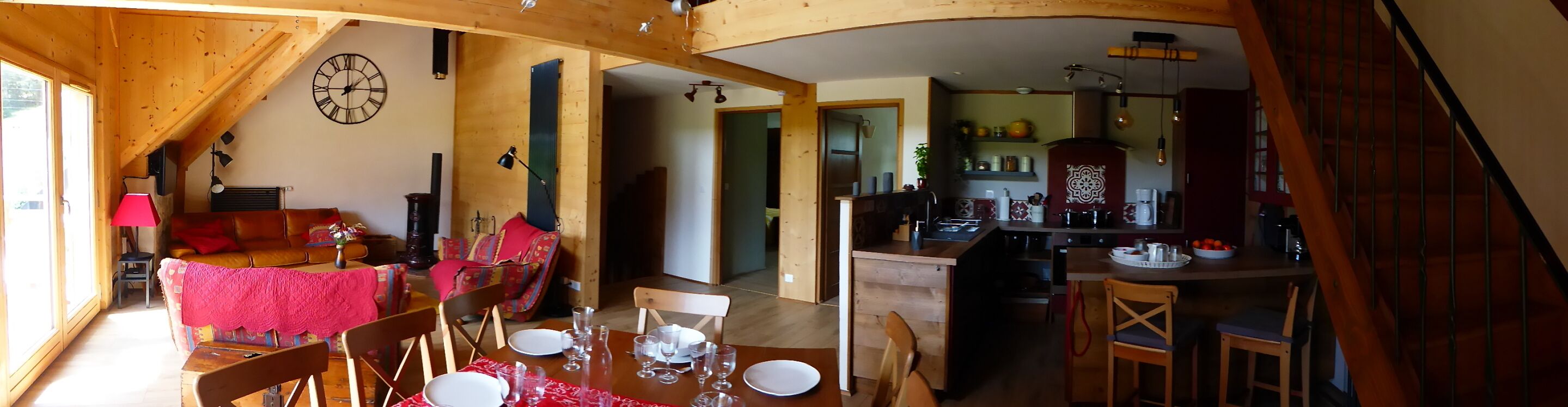 A cozy, rustic interior with a dining area, kitchen, and living space.