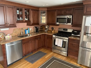 Microwave, dishwasher, coffee/tea maker, cookware/dishes/utensils