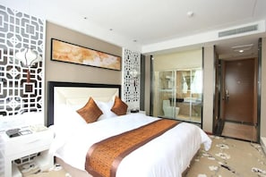 A modern hotel room with a large bed, a desk, and a bathroom visible through a glass door. - Gentleman Hotel (Shenzhen)