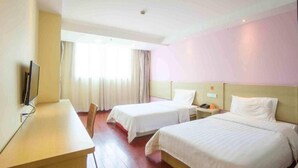 A hotel room with two beds, a desk, and a television. - 7 Days INN Xingguang Avenue (Nanning)