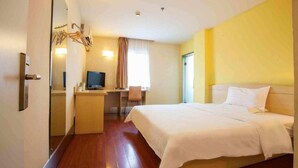 A hotel room with a bed, desk, chair, television, and a mirror. - 7 Days INN Xingguang Avenue (Nanning)
