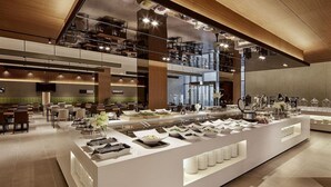 Un restaurant moderne avec un buffet, de hauts plafonds et une vue sur la ville.