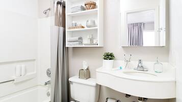Combined shower/bathtub, towels, soap, toilet paper