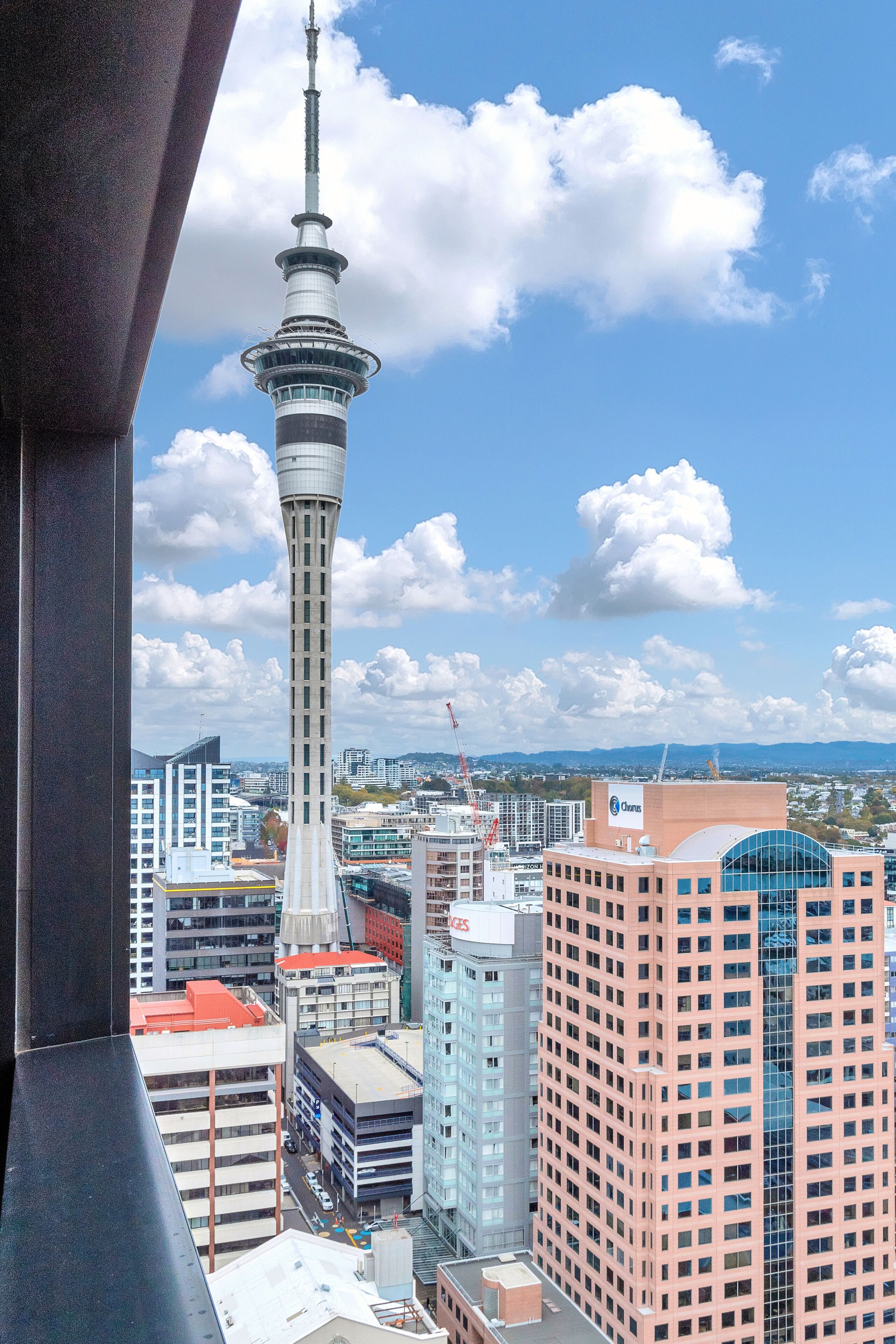 A cityscape with a prominent tower and various buildings.