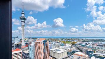 A cityscape with a prominent tower, various buildings, and a clear sky.