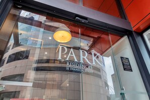 A modern building with a glass facade and the name "PARK Residences" prominently displayed. - Amazing Harbour, Skytower & Rangitoto Views (Auckland)