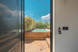 A wooden deck leading to a swimming pool with a clear blue sky above. - Moon And Stars Athens (Athens)