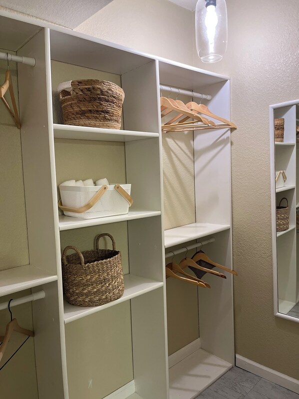 A walk-in closet with shelves, baskets, and hangers. - Swim Dock, Family Fun, Close to Hot spots! (Lake Ozark)