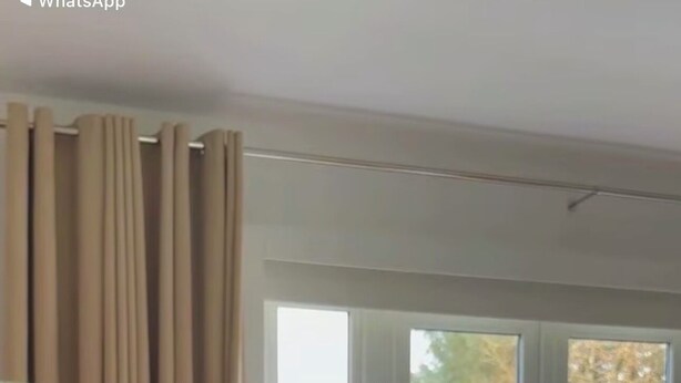 A living room with a blue sofa, a coffee table with flowers, and a view of outdoor patio chairs through a glass door. - Apartment totally private entrance, sauna, shower, bedroom, studio,bathroom.     (Ballynahinch)